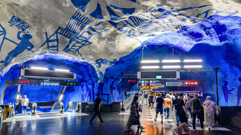 Passengers walk through an underground tunnel in T-Centralen subway station, Stockholm
