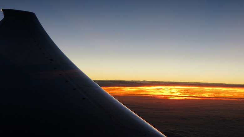 view of sunrise from an airplane window