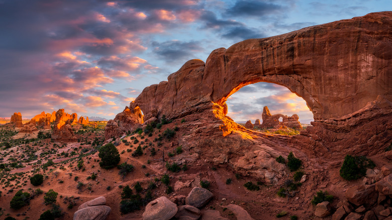 sunset over a stone arch