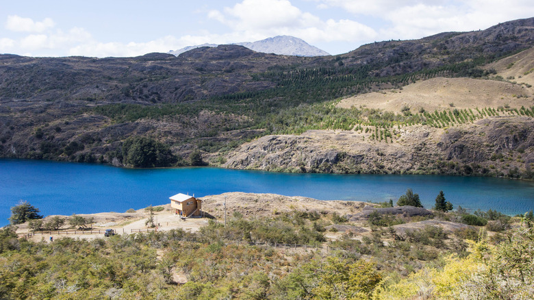 valley and a river view with a small house in arid brush