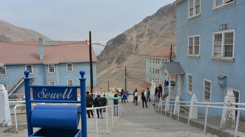 a sign that reads Sewell at the top of the stairs surrounded by old buildings around
