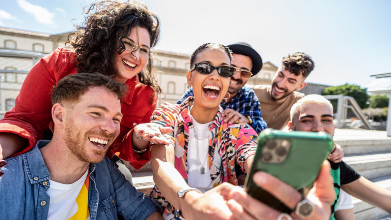 group of people taking a selfie laughing
