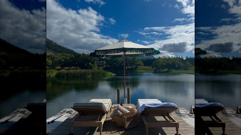 Two empty loungers at a small lake at Sterrekopje Healing Farm