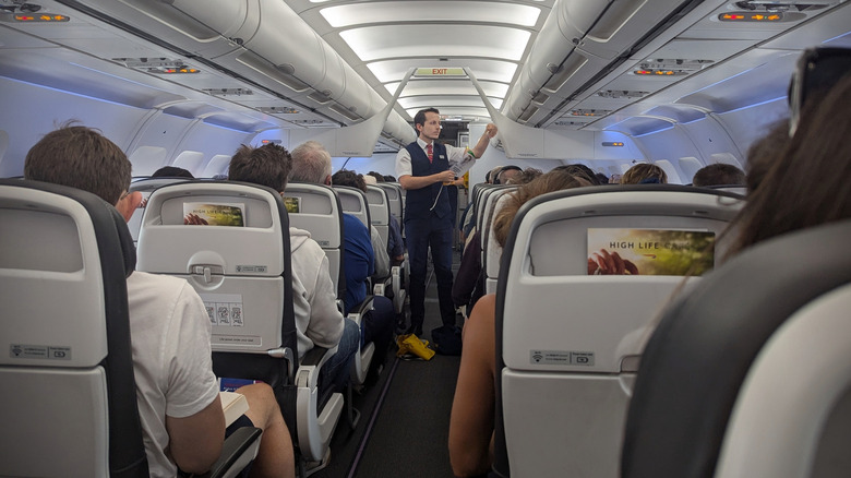 A British Airways flight attendant gives a safety demonstration aboard the plane.