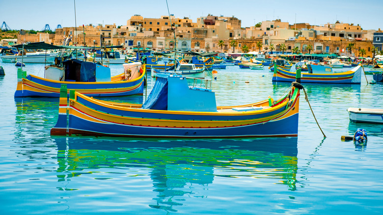 Colorful traditional boats fill the harbor in the village of Marsaxlokk, Malta