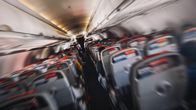 Blur image of a commercial plane moving fast downwards, evoking a fear of flying