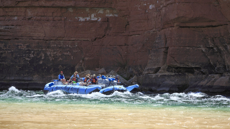 Blue raft navigating rapids on the Colorado River in the Grand Canyon