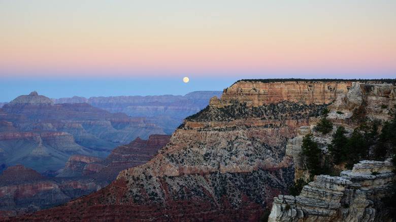 Moon rising over the Grand Canyon at sunset on a clear night