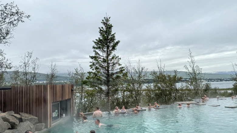 People outside in a hot thermal pool