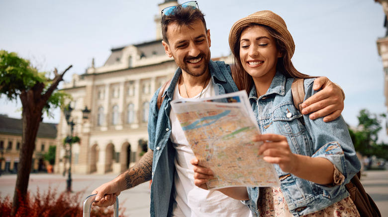 A couple traveling with a map