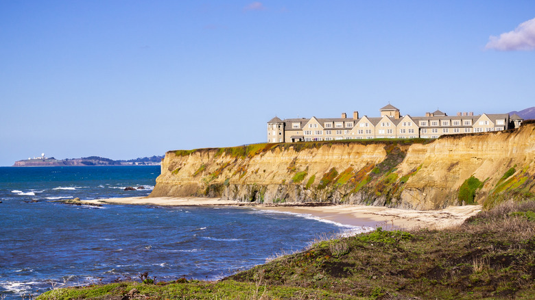 majestic seaside cliffs with hotel in the background on a clear day