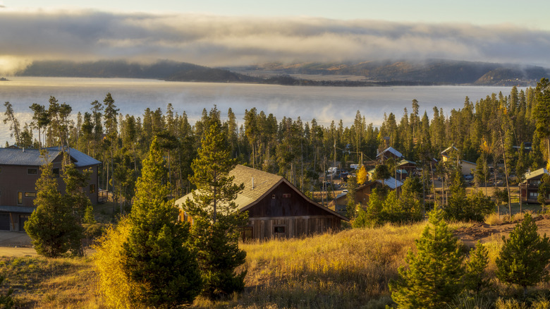 Cabins and buildings making up Granby, Colorado, overlooking Granby Lake, on a foggy day