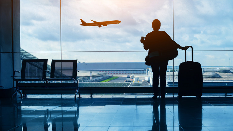 A silhouette of a woman at the airport