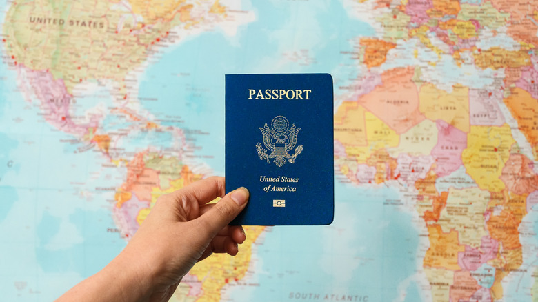 A US passport in front of a world map