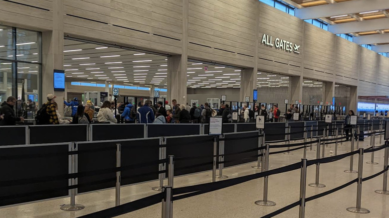 A photo of passengers waiting in the airport security checkpoint at Kansas City International Airport