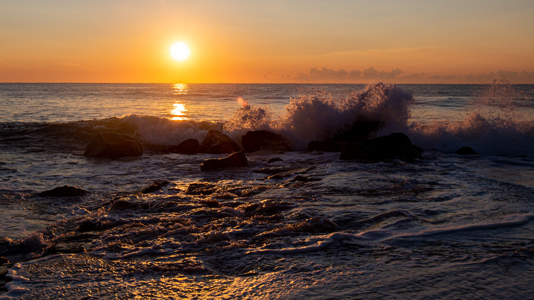 Waves breaking on shore at sunrise on Manasquan Beach, New Jersey