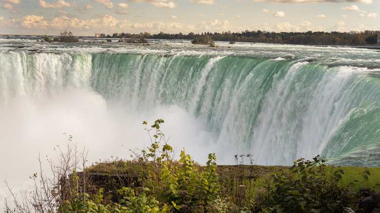 The grandeur of Niagara Falls, with clouds dotting the sky