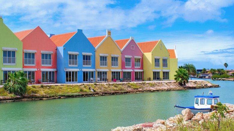 Row of colorful buildings along turquoise water