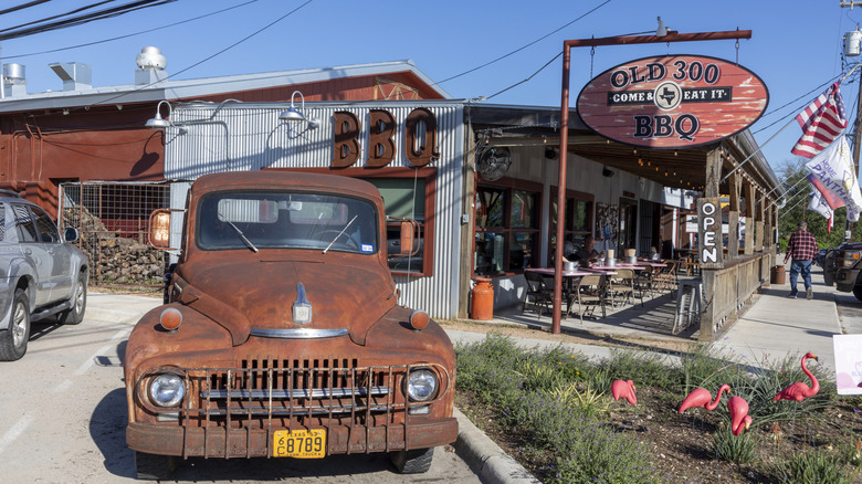 Rusted vintage pickup truck display outside of Old 300 BBQ restaurant in Blanco.