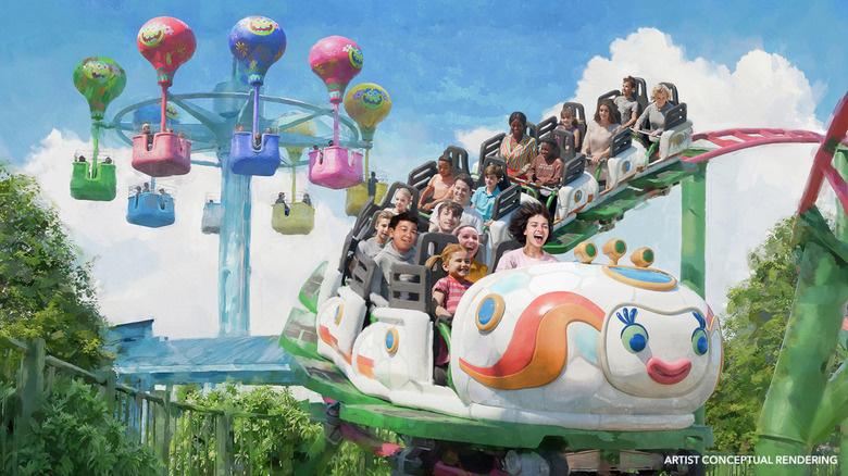 Artist rendering of a Troll-themed roller coaster with smiling children aboard