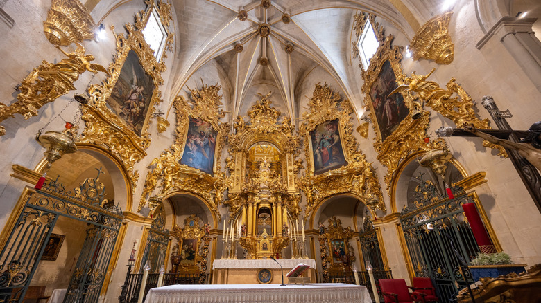 Ornate golden altar and baroque architecture inside the Co-Cathedral of San Nicolás