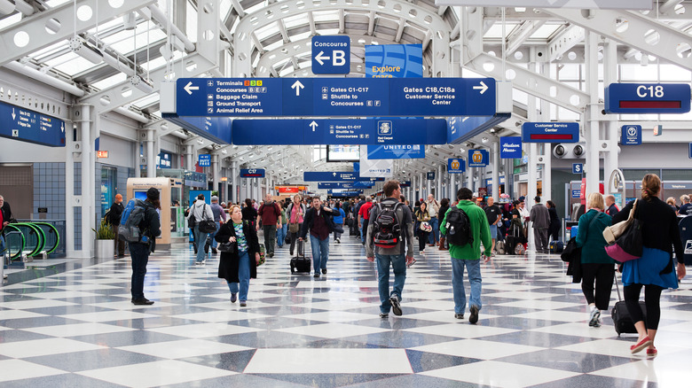 Passengers walking in the terminal at Chicago O'Hare International Airport.