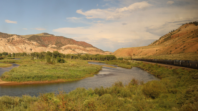 California Zephyr train passing through Colorado amid mountains and river scenery.