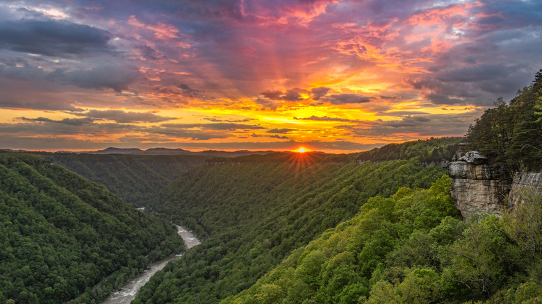 The sun's rays leave behind an explosion of colors as the storm clouds break over West Virginia's New River Gorge from Beauty Mountain