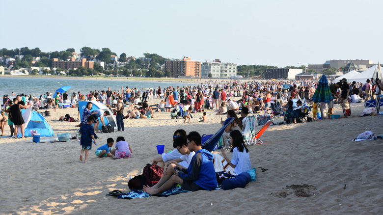 People enjoying the sand along Revere Beach, Massachusetts.