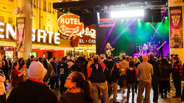 Tourists attending a rock and roll music concert on the Fremont Street Experience at night in Las Vegas