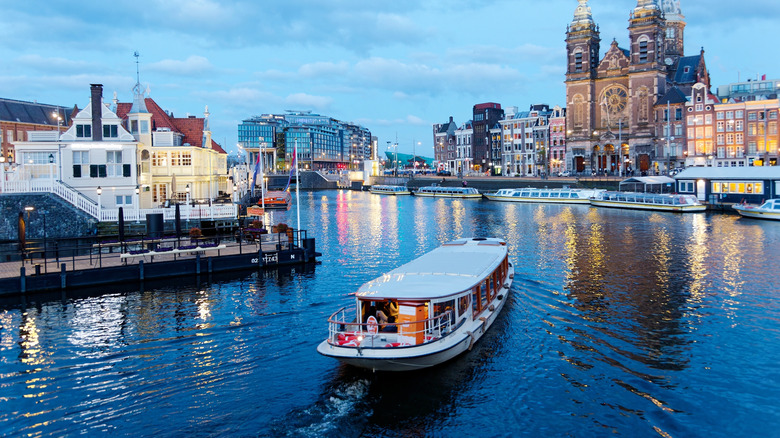 Boat riding along Amsterdam canal