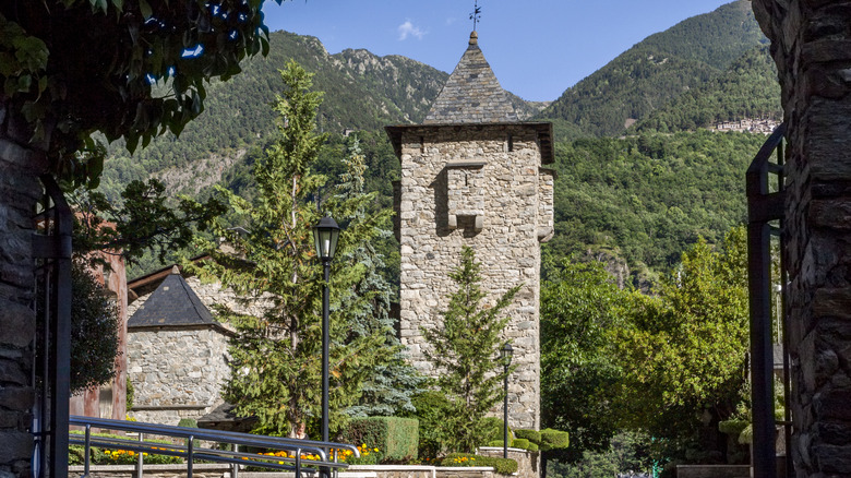Defensive tower of Casa de la Vall, the old parliament building of Andorra with a background of mountains