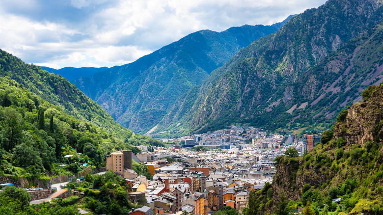 Aerial view over the capital of Andorra, deep in a valley surrounded by lush mountains