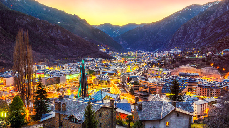 Andorra la Vella in a valley at dusk with lights on
