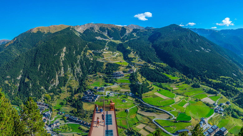 Mirador Roc Del Quer viewpoint with a bronze statue overlooking green mountains and valleys, Andorra