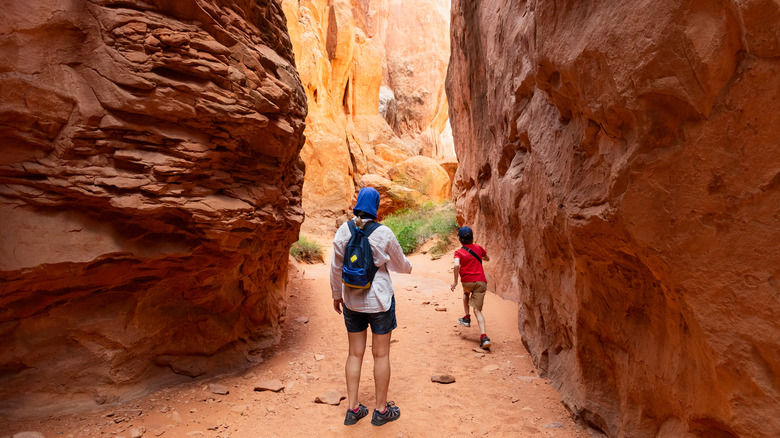 A woman and boy hiking in Arches National Park