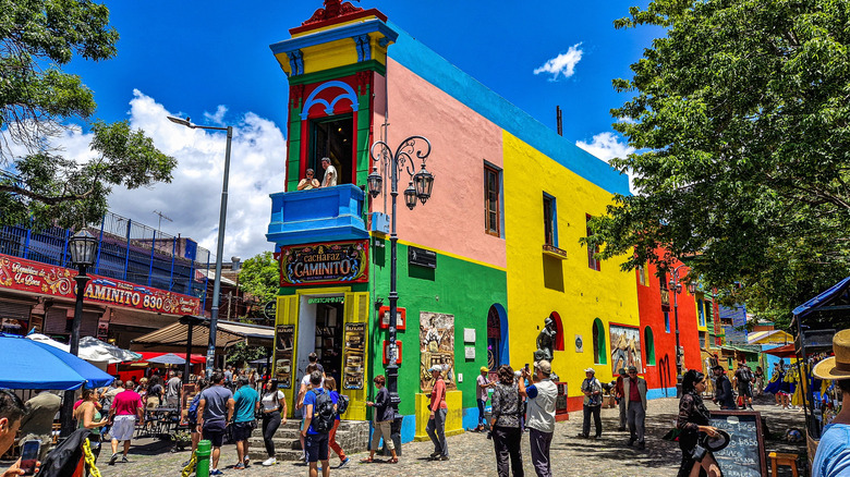 Tourists gathered around colorful buildings in Caminito Street in La Boca neighborhood at Buenos Aires, Argentina.