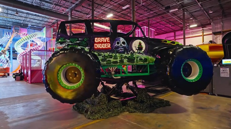 The Grave Digger VR ride in Thrillz Atlanta, with illuminated slides in the background