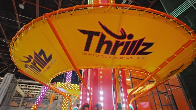 A close-up shot of part of a ride at Thrillz Atlanta, with the Thrillz logo