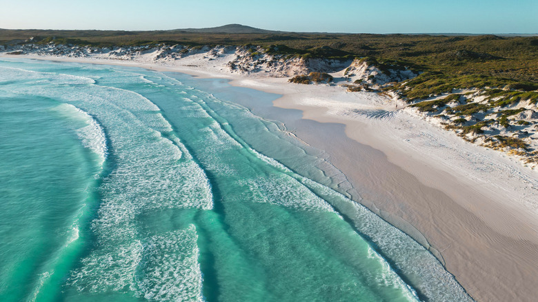 Turquoise waves crash onto the white sands of Wharton Beach, Esperance, Australia