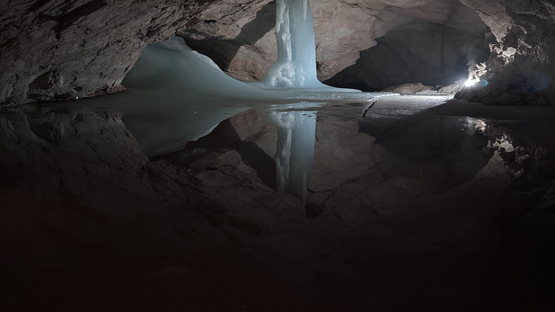 Interior view of Eisriesenwelt, the world's largest ice cave, with blue ice formations and frozen water
