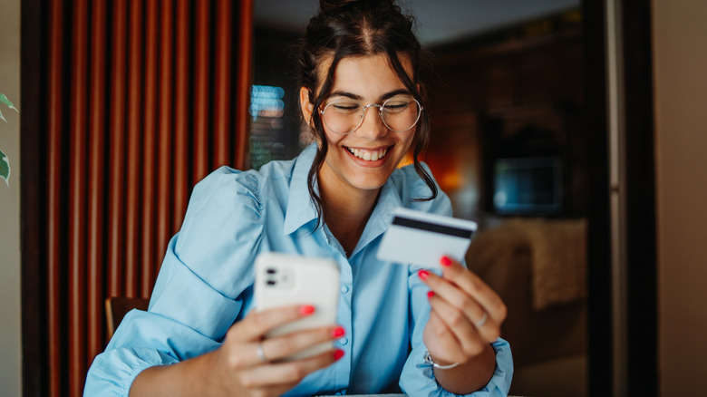 A woman adding a travel notification on her card from her phone