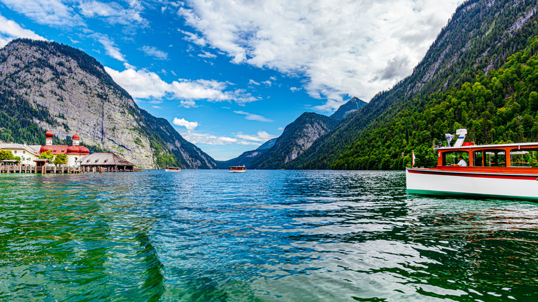 Red and white tourist boat on the blue waters of Lake Konigsee in the Alps, Germany