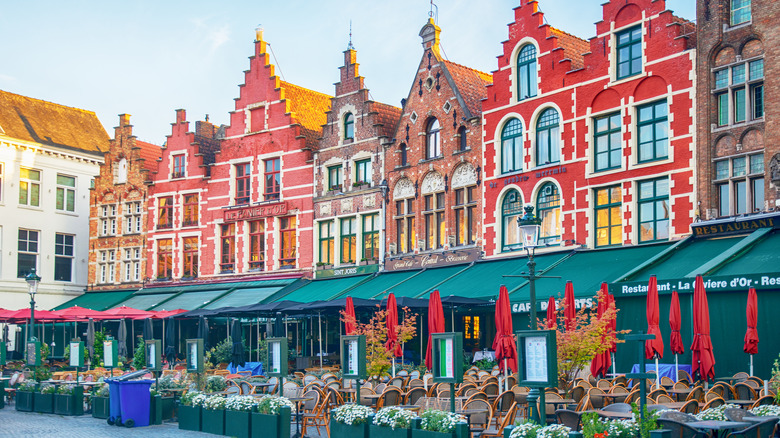 Colorful facades and restaurants in a square in Bruges