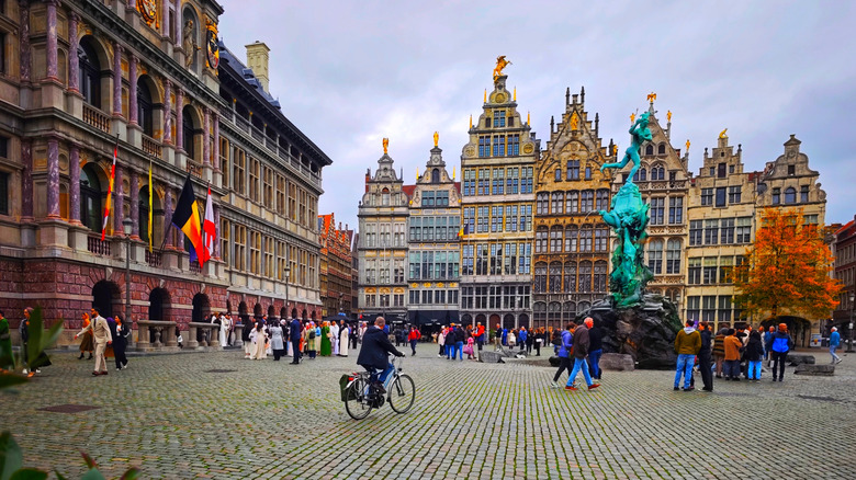 People stand and bike around the Grote Markt in Antwerp