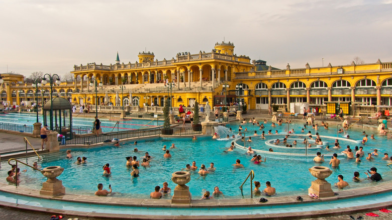 Busy pool outside yellow palace of Budapest's Széchenyi Baths