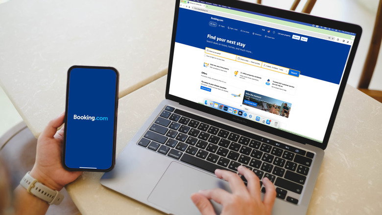 Booking.com application homepage icon on a laptop and iPhone screen