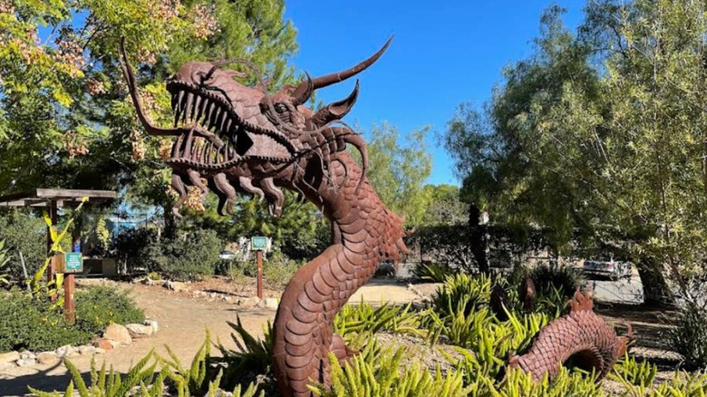 A metallic dragon sculpture in the Alta Vista Botanical Gardens