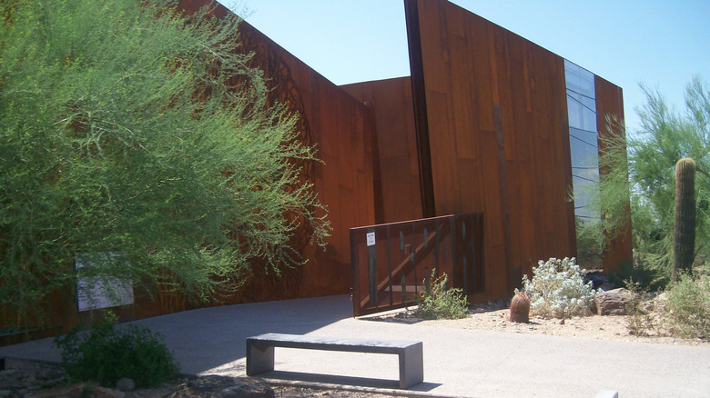 Steel and glass exterior of Arabian Library in Scottsdale surrounded by shrubs
