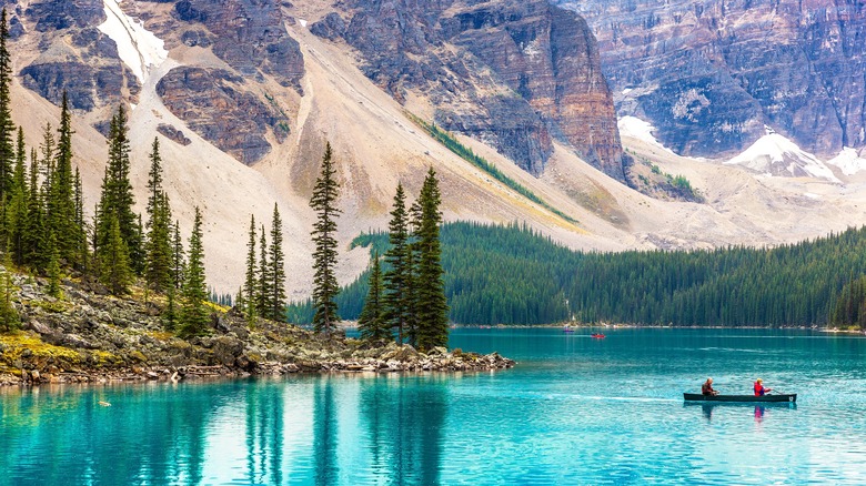 Tourists canoe on Lake Moraine in Banff National Park